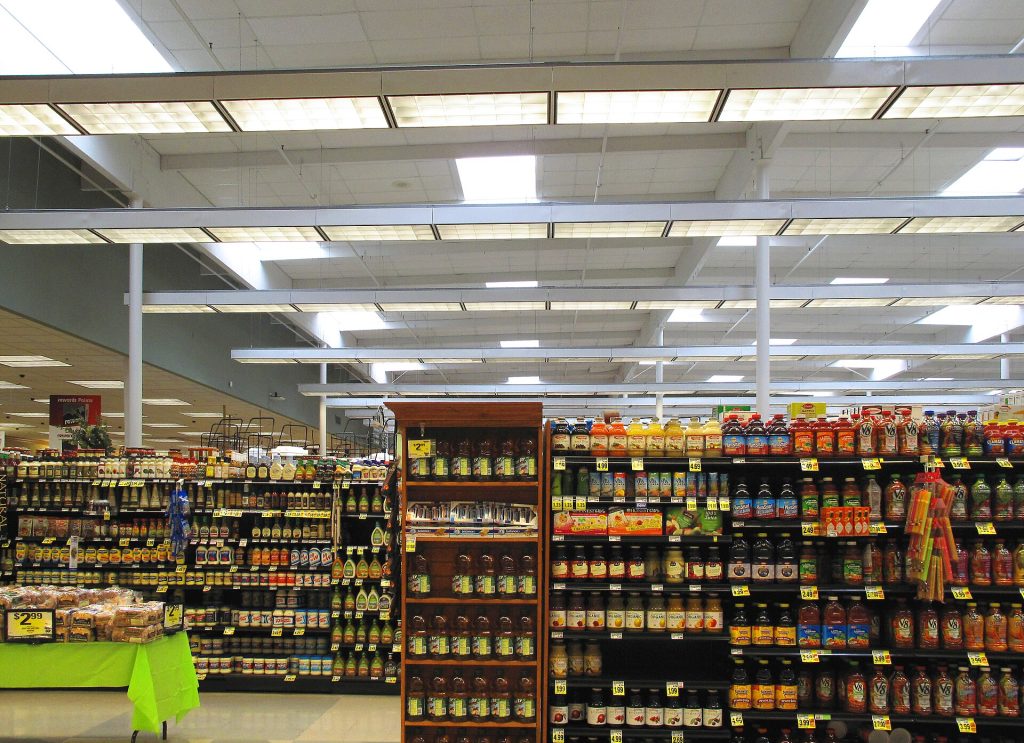 Ultra-Processed Food Research: Separating Evidence From Hype A grocery store aisle with shelves of packaged snack foods and biscuits